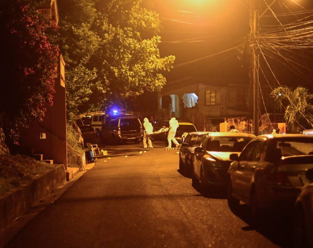 Undertakers remove the body of murder victim Kerlon Thomas from Friendsfield Road, Tobago, on August 21. - Photo courtesy Visual Styles