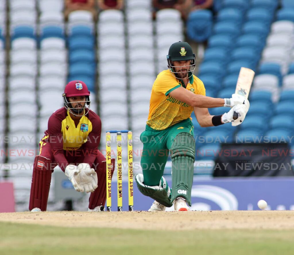 South Africa batsman Reeza Hendricks plays a shot against West Indies as wicket-keeper Nicholas Pooran looks on at the Brian Lara Cricket Academy. The photo shows the empty seats during the first T20 on August 23.  - Photo by Lincoln Holder 