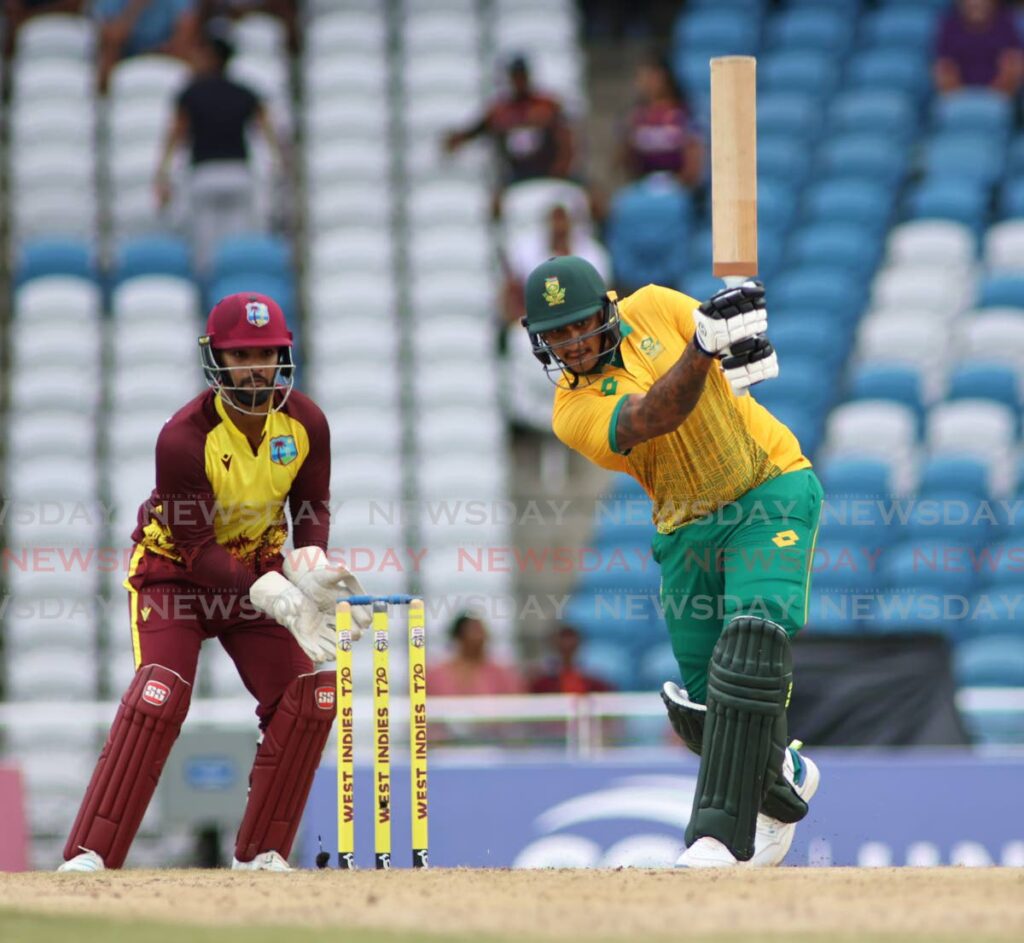 South Africa batsman Tristan Stubbs plays a shot against the West Indies in the first T20 as wicket-keeper Nicholas Pooran looks on at the Brian Lara Cricket Academy, Tarouba on August 23. - Photo by Lincoln Holder