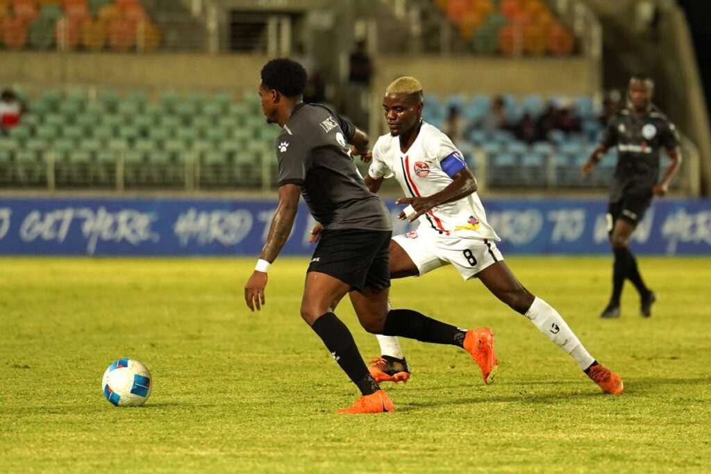 Miscallenous Police playmaker Joevin Jones (L) is confronted by Real Hope FA's Daniel Saint Fleur during their Concacaf Caribbean Cup opener at Sabina Park, Jamaica on August 22. Photo courtesy Oneil Miller/Straffon Images.  - 