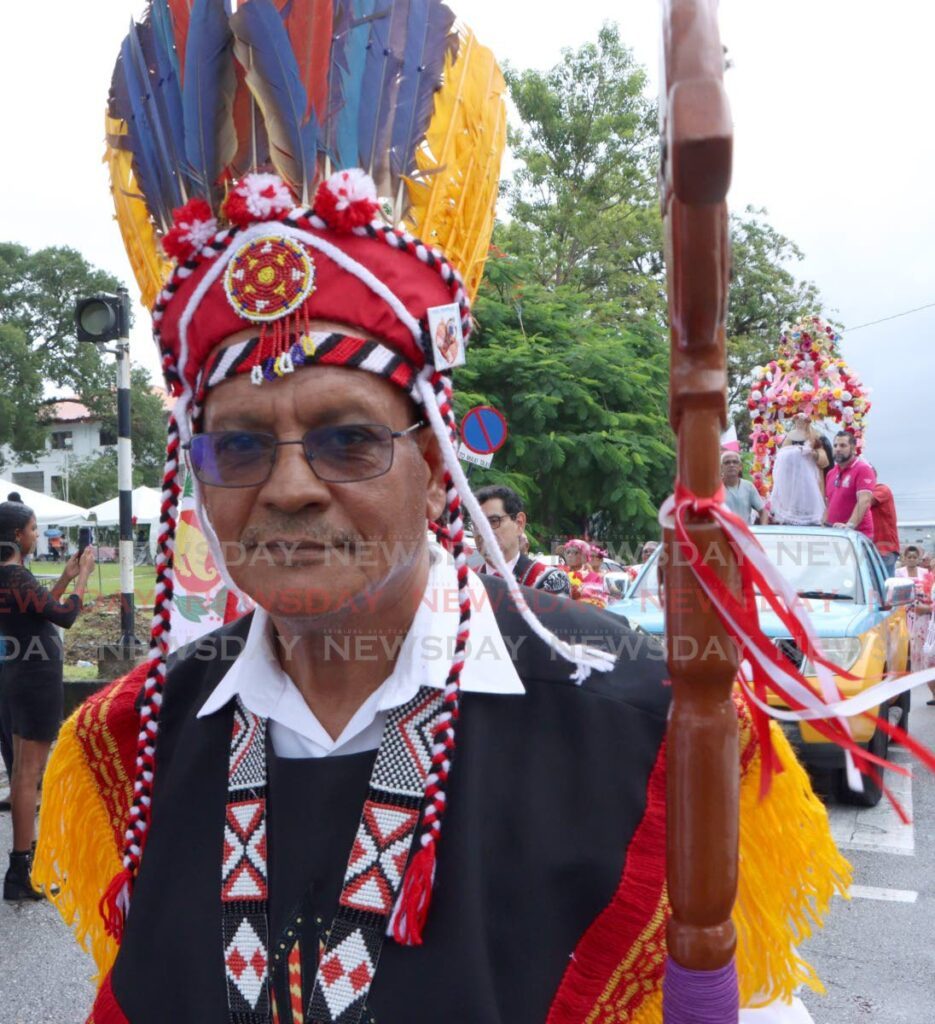 Chief of the Santa Rosa First People's Community Ricardo Bharath-Hernandez walks in from the Saint of Santa Rosa during the Festival of Santa Rosa procession on Woodford Street, Arima on August 25. - Photo by Angelo Marcelle