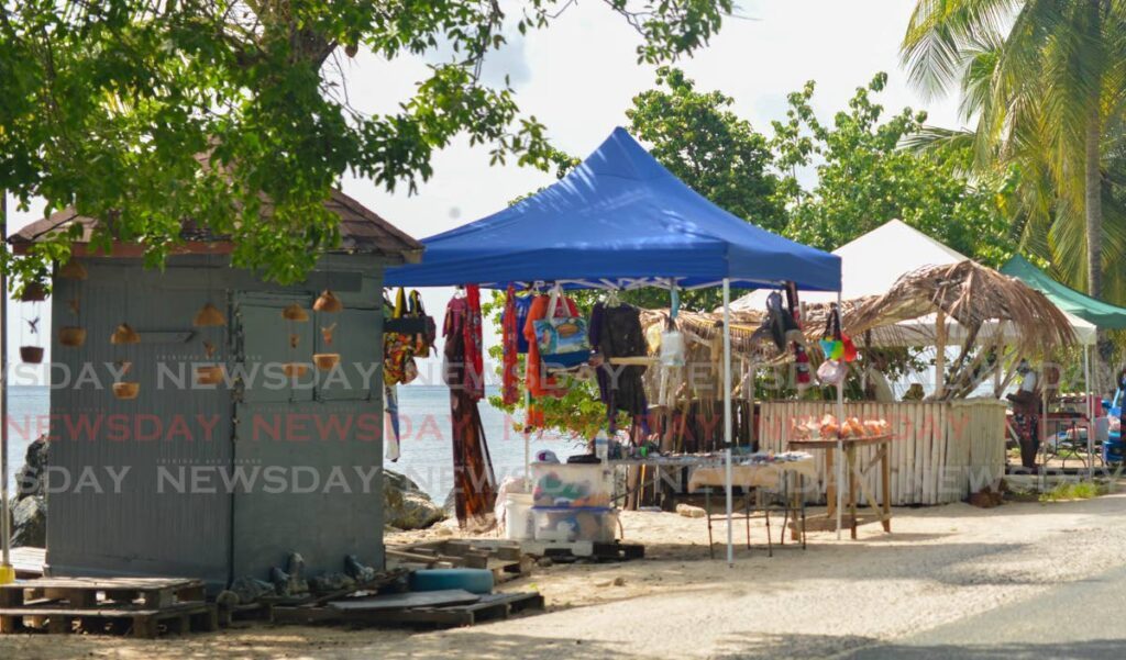 Vendors sell under tents at Swallows Beach, Tobago, on August 26. - Visual Styles