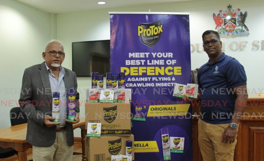 Siparia Mayor Doodnath Mayhroo, left, and Ashuk Mirhai, DTT channel manager on the Protox on the handing over of mosquito repellents on the Siparia Borough Corporation unprejudiced lately. - 