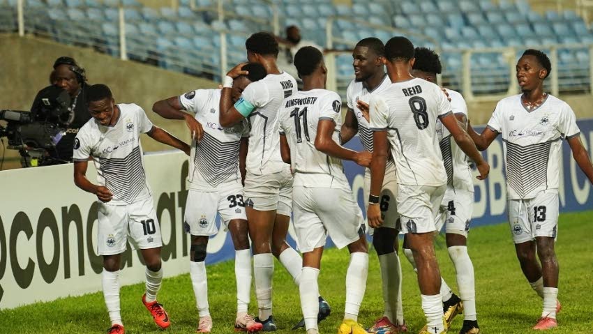 Cavalier FC players celebrate a goal against Police FC at Sabina Park, Jamaica on August 29. - 