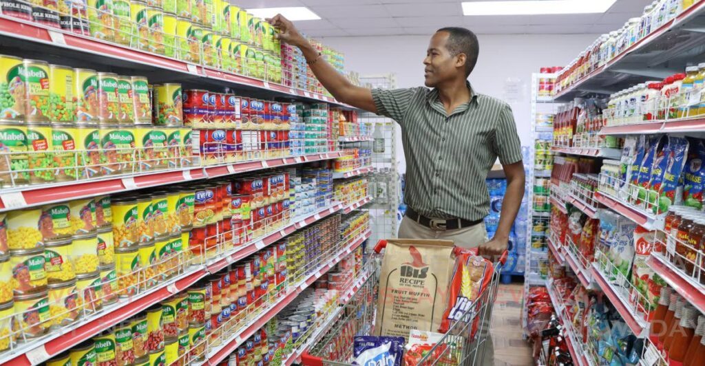 Barry Telesford fills his shopping cart at a grocery store in Port of Spain. 
Central Bank in its monetary policy on September 27 reported that food inflation has eased, falling from 2.3 per cent in June to 1.5 per cent in August. - File photo by Faith Ayoung