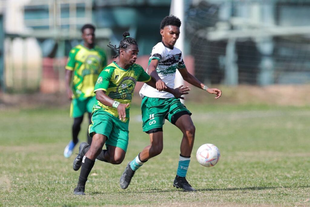 A Signal Hill Secondary player, left, vies for the ball against his St Augustine Secondary opponent in a SSFL Big 5 match in February 2024. - DANIEL PRENTICE