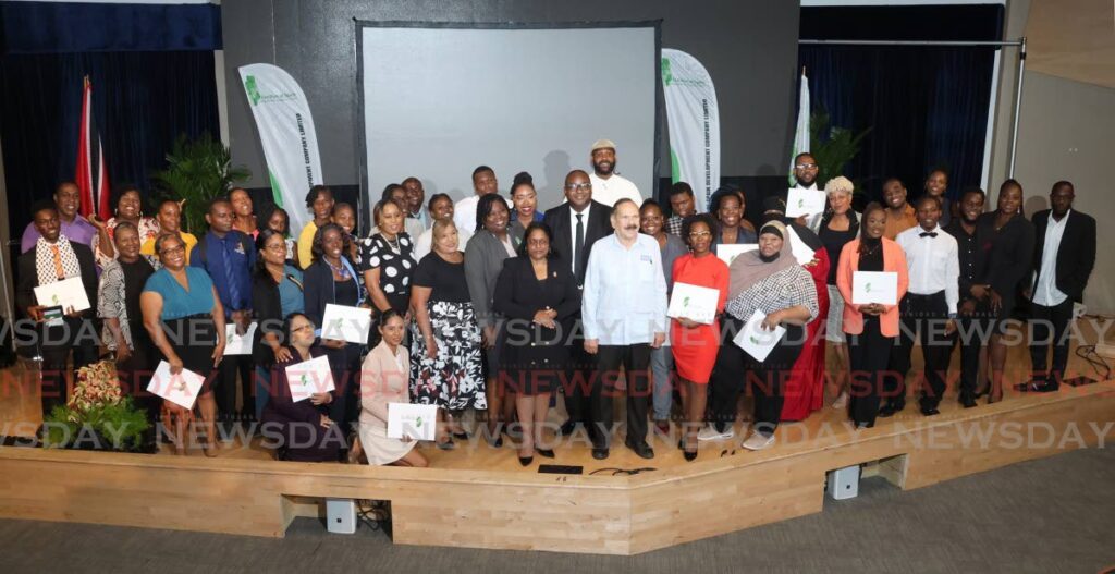 Graduates of the EPOS vocational short courses programme are pictured with Hillan Morean, EPOS chairman, centre, Shanmatee Singh Ng Sang, permanent secretary in the Ministry of Housing, centre-left and Prof Clement Imbert, MIC chairman, centre-right, at the Social and Economic Programmes (SEP) Graduation and Career Day held at the Government Campus Plaza Auditorium on Richmond Street, Port of Spain on August 21. - Photo by Faith Ayoung