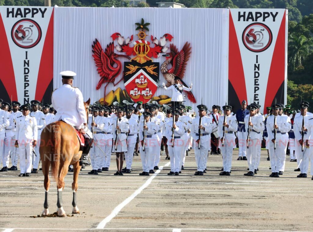 Members of the protective services stand at attention during the parade to mark 62 years of independence on August 31. - Photo by Ayanna Kinsale