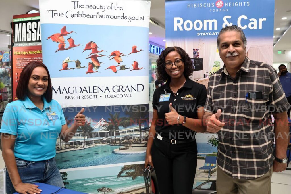 Darwin Samlalsingh, right, books his stay at Magdelena Grand Beach and Golf Resort, while shopping at C3 Centre in San Fernando on August 31. Samlalsingh was assisted by Magdalena sales manager Carineh Deokiesingh, left, and sales co-ordinator Melanie Forbes, at a pop-up event organised by the Tobago Hotel and Tourism Association. - Photo by Venessa Mohammed