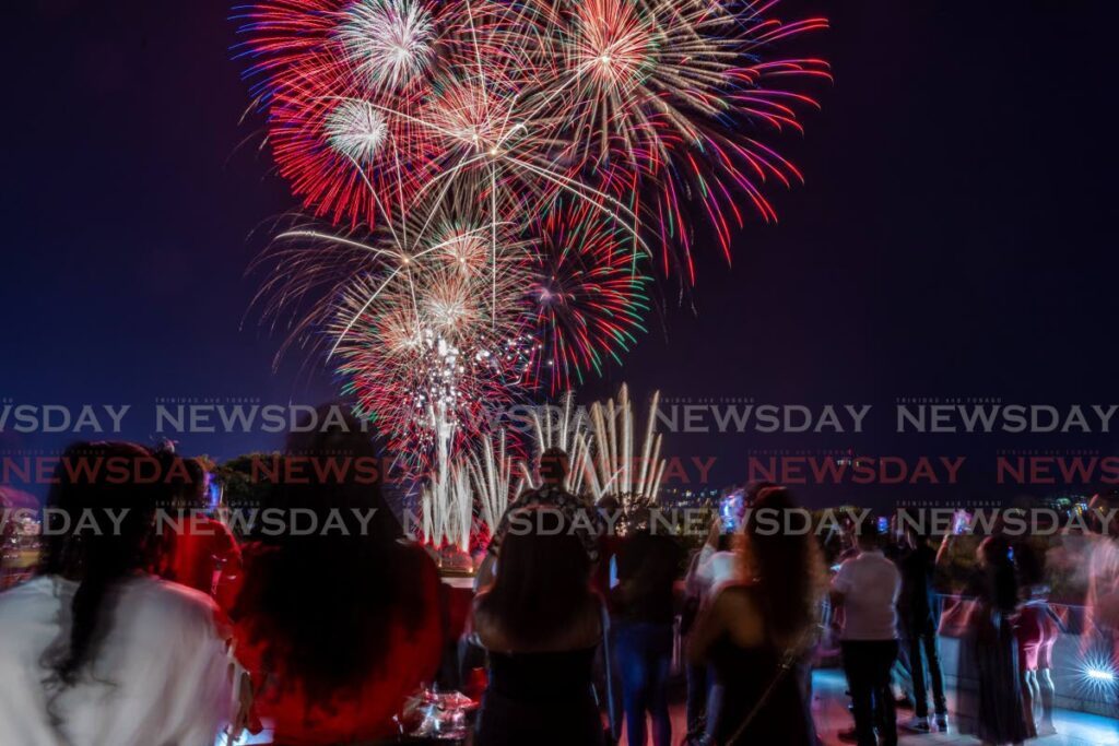 Staff of the NIBTT enjoy the fireworks display at the Queen’s Park Savannah for the 62nd Independence Day celebration from the rooftop of NIBTT on August 31. - Photo by Jeff K Mayers 