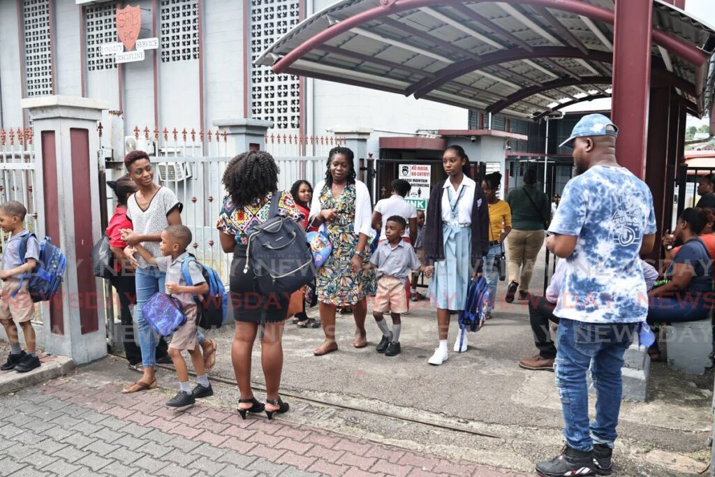 HOMETIME: Parents collecting their children at San Fernando Boys’ RC school, Harris Promenade after the first day of school on September 2.  - Photo by Lincoln Holder 