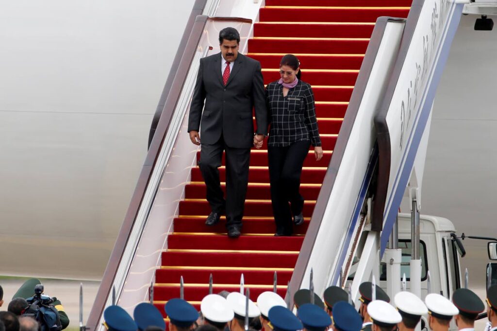 Venezuela's president Nicolas Maduro, left, and first lady Cilia Flores arrive at Beijing Capital International Airport in Beijing, China on September 1, 2015. - AP PHOTO 