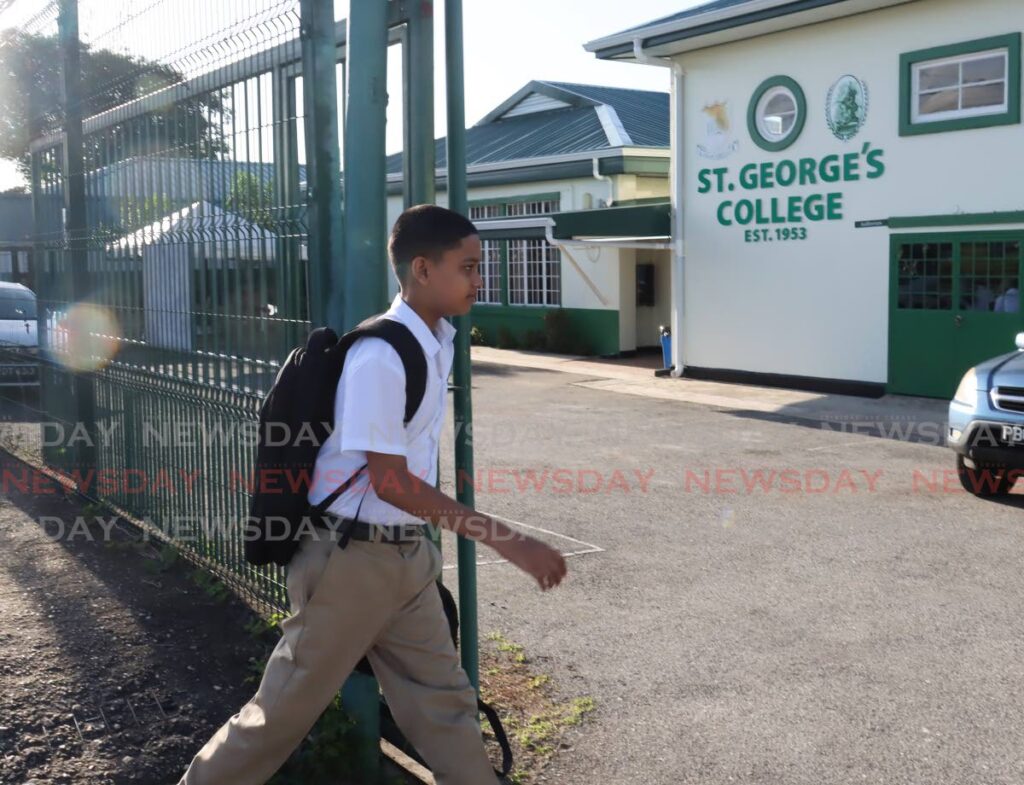 Joshua Fleary, 12, of form 1 walks onto the St George’s College compound before the start of the school day on Tenth Street, Barataria on September 4. - Photo by Faith Ayoung