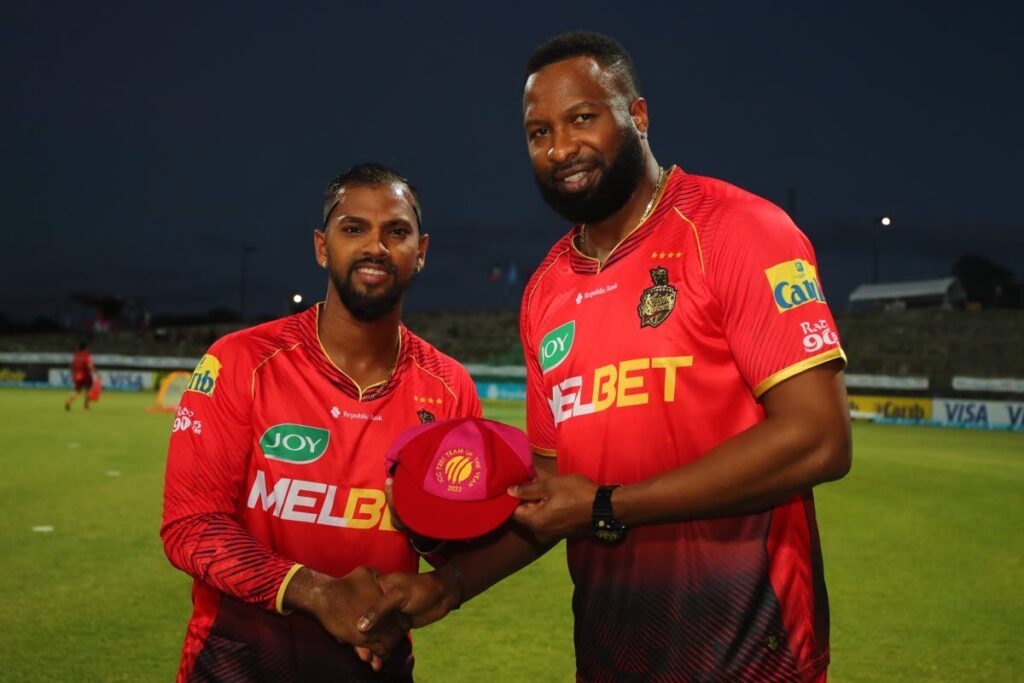 Trinbago Knight Riders big name player Nicholas Pooran (left) is supplied with his ICC T20I Group of the one year 2023 cap by captain Kieron Pollard earlier than play right thru the 2024 Republic Bank CPL on the Sir Vivian Richards Stadium in North Sound, Antigua on  September 5. (Characterize by Ashley Allen - CPL T20/CPL T20 thru Getty Photos) - 