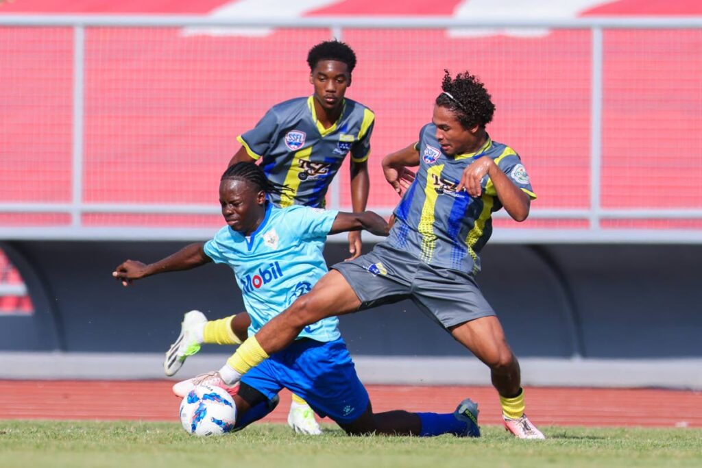 (FILE) Luke Correia of Fatima College, right, steals the ball from Presentation College, San Fernando player Micah Brathwaite during the SSFL NGC Super Cup match at Hasely Crawford Stadium on September 6 in Mucurapo. Correia scored the first goal in Fatima College’s 2-1 win. PhotoS by Daniel Prentice - 