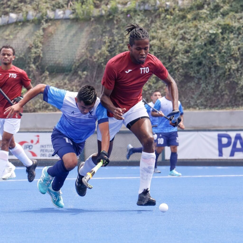 TT men's hockey player Teague Marcano (R) tussles for the ball with a Guatemalan opponent during their Pan American Challenge encounter at the Andres Avelino Caceres Complex in Lima, Peru on September 7. Photo courtesy Pan American Hockey Federation.  - 