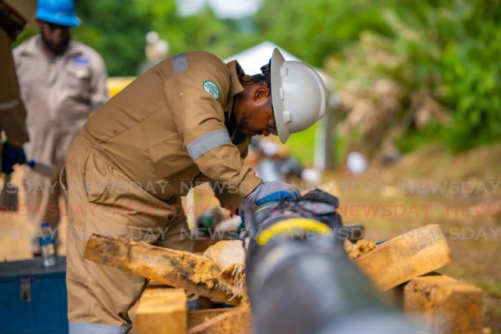  A worker installing a pipe as part of bpTT's Ocelot project to replace some 13 kilometers of new pipeline. - Photo courtesy bpTT