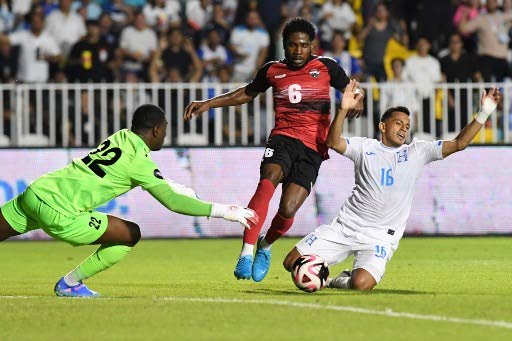 TT's Andre Raymond (C), Honduras' Edwin Rodriguez(R) and TT's Denzil Smith fight for the ball during the Concacaf Nations League group stage match, at the National stadium in Tegucigalpa, on September 6.  - 