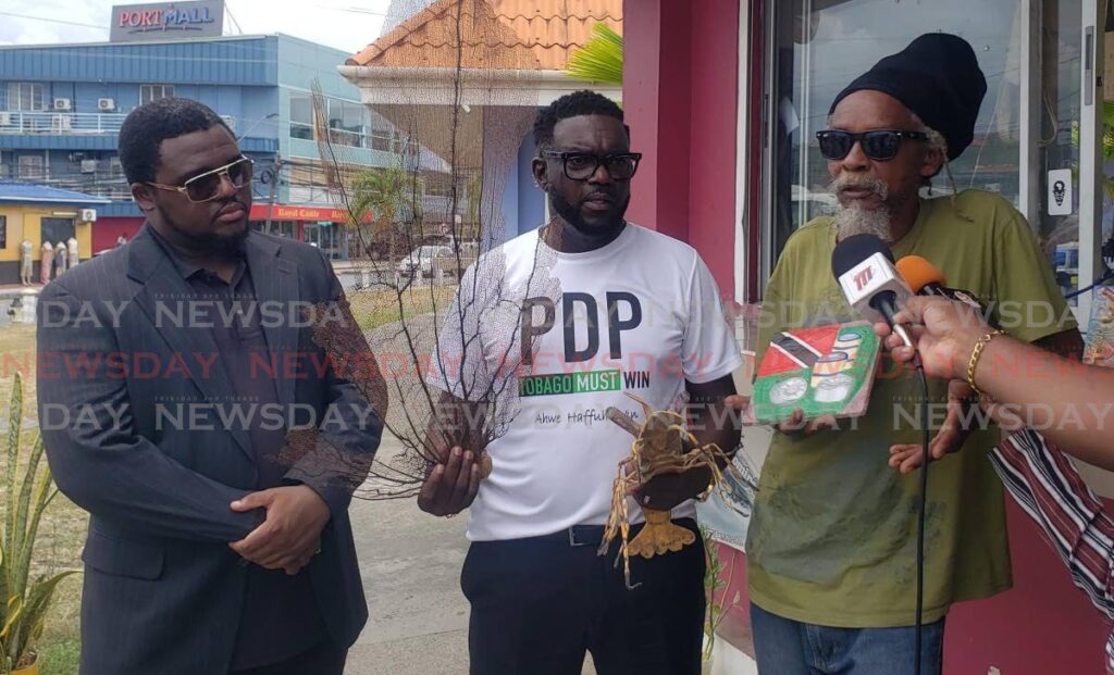 Vendor Ian Seon, right, with PDP leader Watson Duke, centre, and PDP chairman Dr Sean Nedd at the Scarborough Esplanade on September 9. - Photo by Kinnesha George-Harry