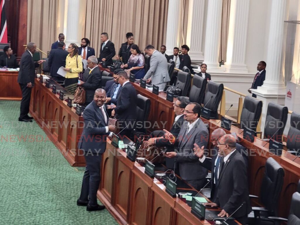 Minister of Youth Development and National Service Foster Cummings, left, jokes with UNC MPs Rushton Paray, Dinesh Rambally, Rodney Charles and Dr Rai Ragbir after they were separated from their colleagues on the Opposition bench on September 9.   - FILE PHOTO