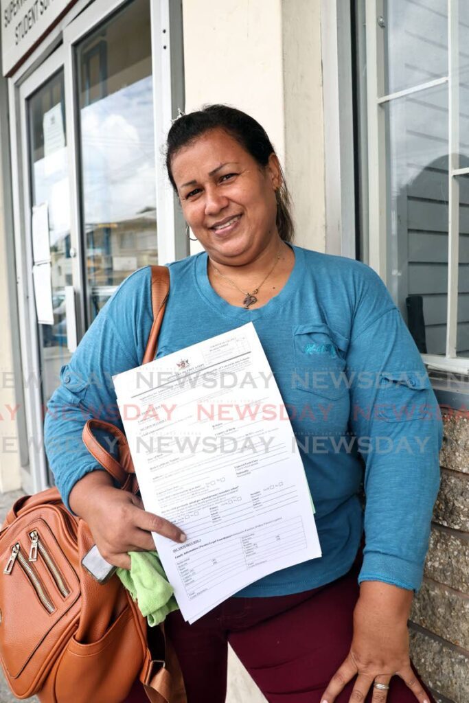 Venezuelan migrant Yolenny Moya, a mother of two children, with her registration forms at the Ministry of Education, Victoria district office on Sutton Street San Fernando. Moya is seeking to have her children enrolled in school. - Photo by Lincoln Holder 