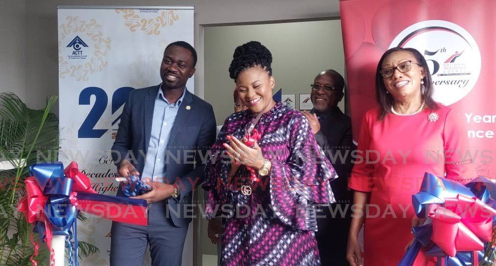 Chief Secretary Farley Augustine, left, Education Minister Dr Nyan Gadsby-Dolly, centre, and Dr Ruby Alleyne, chairman, NTA and ACTT, rejoice after lowering the ribbon for the outlet of the NTA and ACTT's new reveal of job at D'Collosseum, Crown Point on September 10. - Photo by Corey Connelly