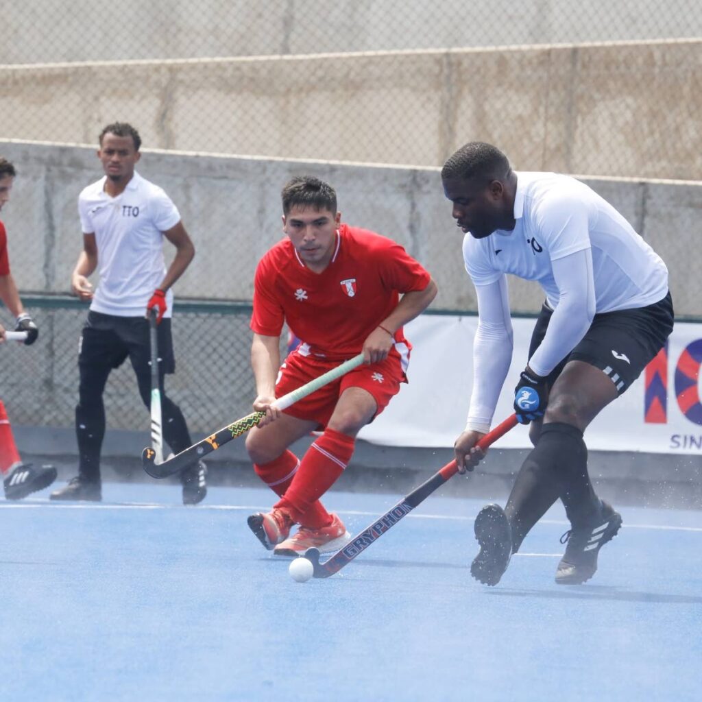 TT men's hockey player Shaquille Daniel (right) takes on a Peruvian opponent during their Pan American Challenge encounter at the Andres Avelino Caceres Sports Complex, Lima, Peru on September 10. Photo courtesy Pan American Hockey Federation.  - 