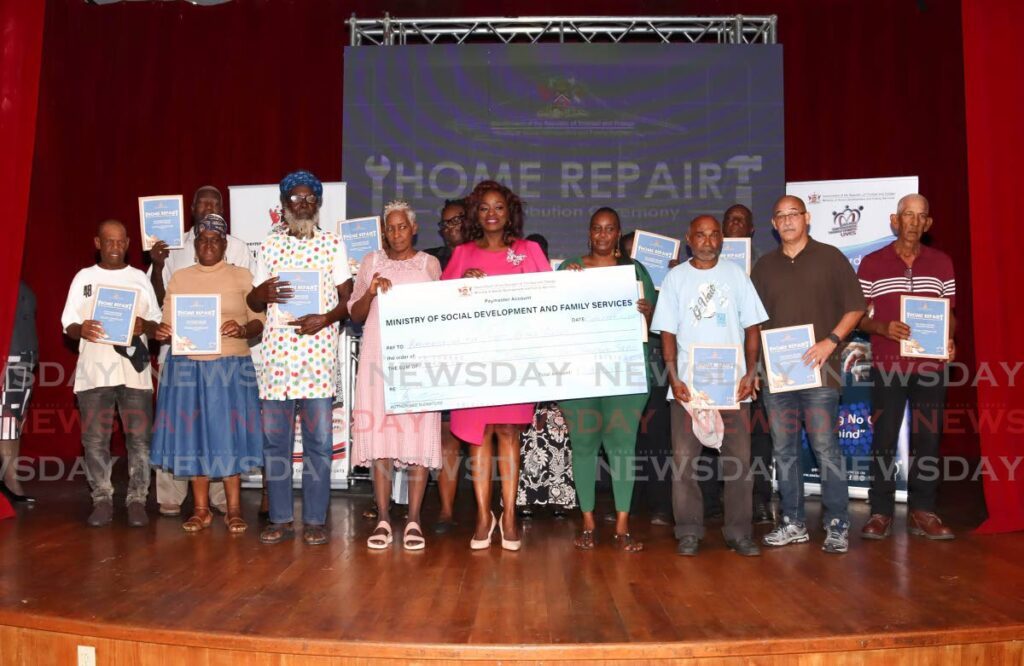 Minister of Social Development and Family Services Donna Cox, centre, with the recipients of home repair grants at the distribution ceremony held at City Hall, Knox Street, Port of Spain on September 11. - Photo by Gabriel Williams