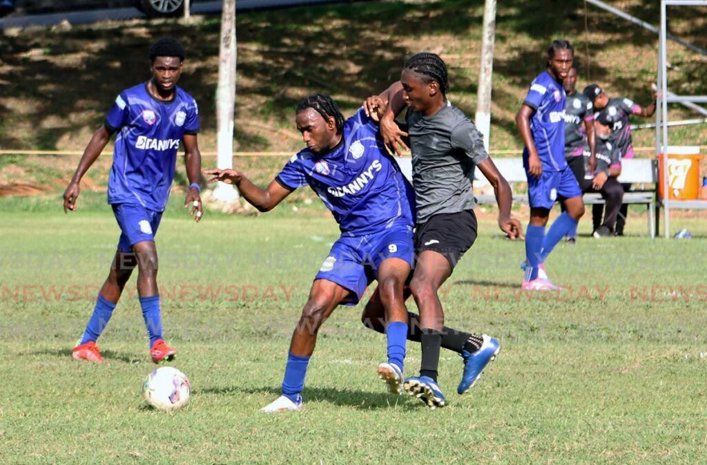 Naparima Collage’s, Xarion France, centre, battles for the ball with an East Mucurapo player during the opening SSFL Premiership match at Lewis Street in San Fernando on September 11. - venessa mohammed 