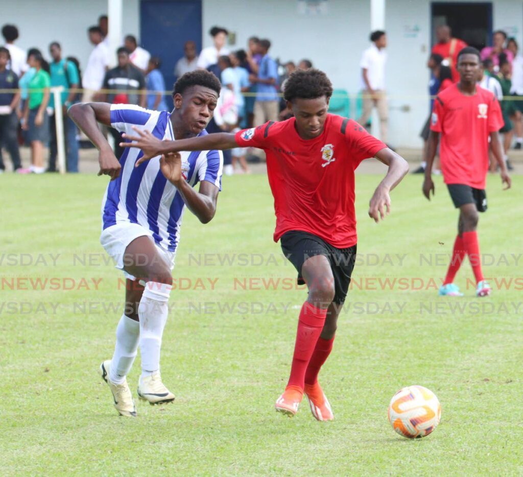 Terique Theobald (R), of St Anthony’s College, wards of the pressure from Manswell Jaylon of St Mary’s College, during their SSFL premiership division match at St Mary’s College Grounds, St James on Septmeber 11. - Photo by Angelo Marcelle