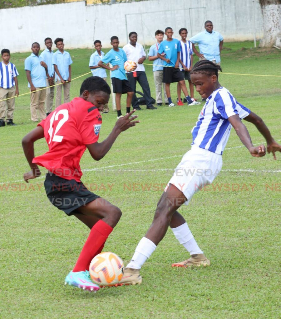 Keemali Decaine of St Anthony's College, left, and Joshua Morris of St Mary's College, battle for the ball during their SSFL premiership division round one match at St Mary's College Grounds, St Clair on September 11. - Photo by Angelo Marcelle