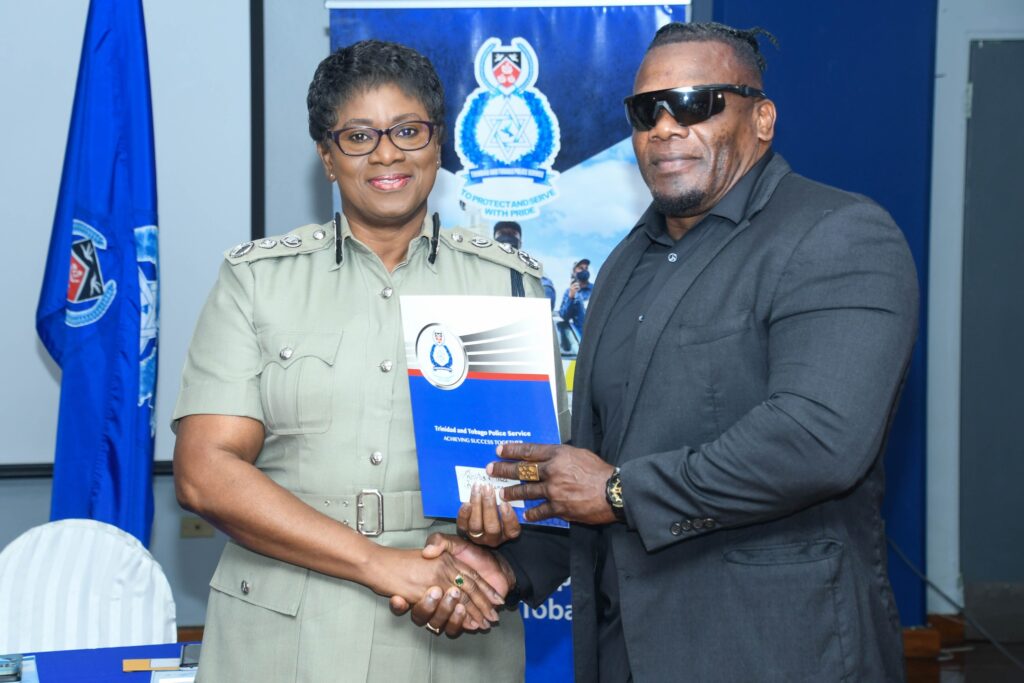 Police Commissioner Erla Harewood-Christopher, left, hands Snr Supt Roger Alexander at TTPS Administrative Building in Port of Spain on September 12. - Photo courtesy TTPS