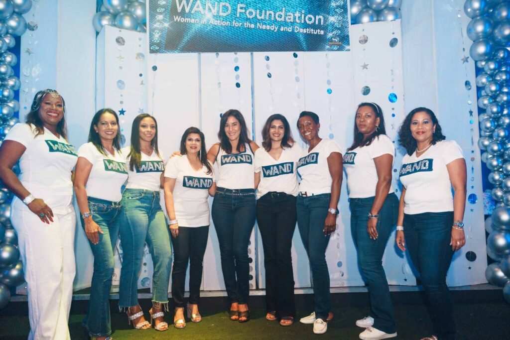 The board of WAND takes a moment under the the spotlight at Denim and Diamonds on September 7 at the Residence Nightclub, Woodbrook. - 