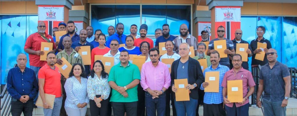 Minister of Agriculture, Land and Fisheries Kazim Hosein, fifth right, and minister in the ministry Avinash Singh, to his left, with members of the Agro-Incentive Assessment Committee and recipients of the Agro-Incentive Grant on September 14 at the ministry in Chaguanas. - 