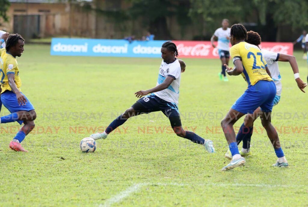 Queen's Royal College's Stephon James (C) controls the ball against Presentation Collge San Fernando during the Secondary Schools Football League Premiership division match, on September 14, at the Queen's Royal College Grounds, Port of Spain.  - Photo by Ayanna Kinsale 