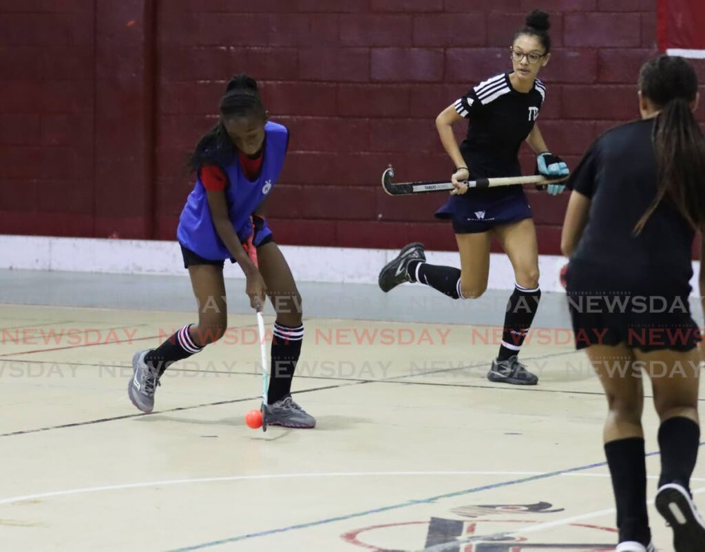 A player from Magnolia, left, controls the ball against a Combined team in the Paragon Indoor Hockey tournament under-21 final at the Woodbrook Youth Facility, Woodbrook, September 15. - Photo by Ayanna Kinsale  