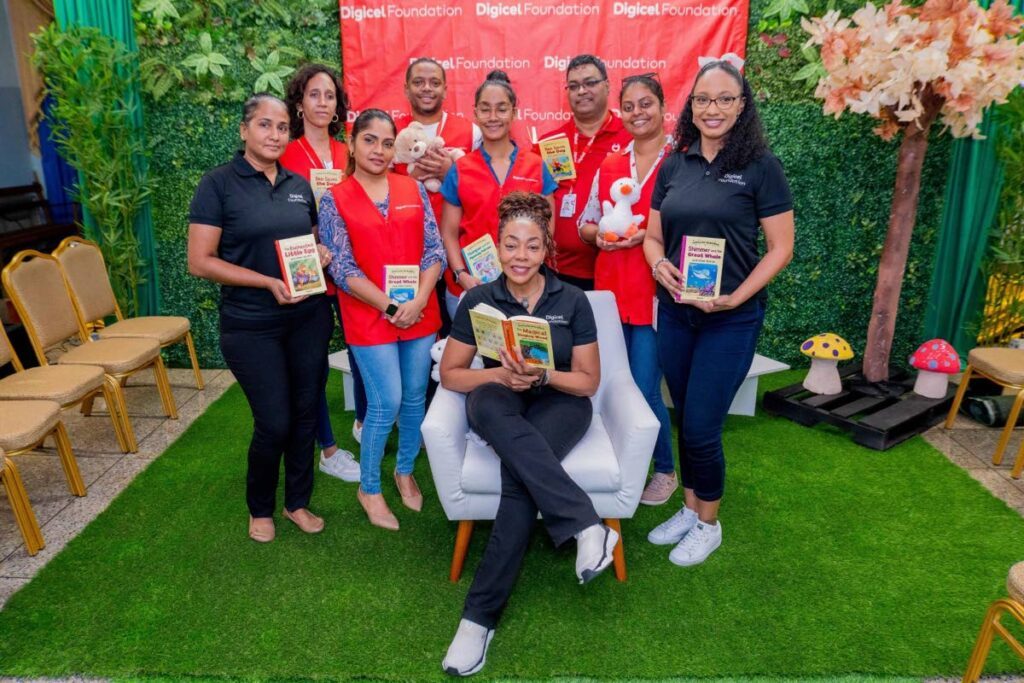 Digicel Foundation CEO Penny Gomez, seated centre, is joined by some of the day’s volunteer readers at the foundation's Unlocking Worlds: Literacy and Inclusion for All. - 