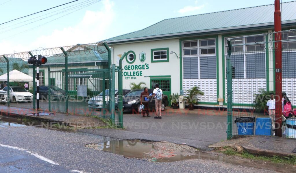 Students leave St George's College on September 17 after sharp, heavy midday showers led to the Barataria school being flooded for several hours. - Photo by Angelo Marcelle