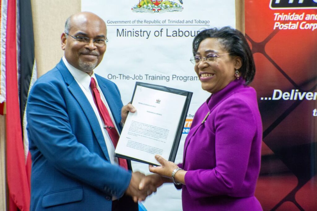 TTPost managing director George Alexis, left, and Natalie Willis, permanent secretary, Ministry of Labour, have partnered to allow 26 young OJTs to gain experience. Photo courtesy TTPOST - 