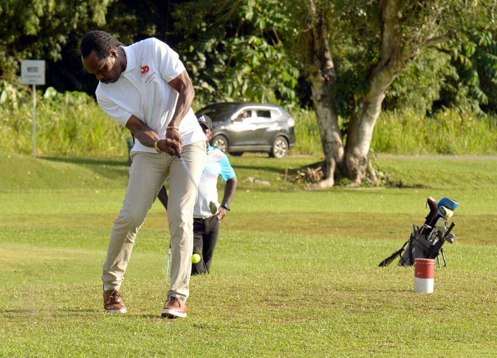 Minister of Nationwide Safety Fitzgerald Hinds tees off at a past golf tournament. -                       