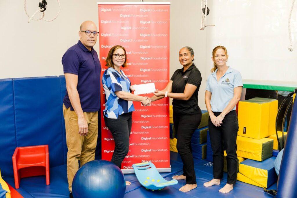  The Digicel Foundation’s project officer Diana Mathura-Hobson, centre right hands over a donation to Sofia Figueroa-Leon,vice chair of CKFTO, centre left, in the company of Samuel Everdium, Cuevas Medek Exercises (CME) specialist, left, and Krista Hamel-Smith, general manager, CKFTO, right.   - 