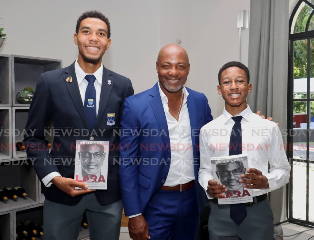 From left, Liam Gooding, 18, of Fatima College, former West Indies batsman Brian Lara and Johann Fournillier, 12, at the launch of Lara's book Lara: The England Chronicles at his home on Lady Chancellor Hill, Port of Spain on September 17. - Photo by Faith Ayoung