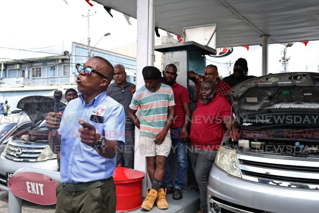 BRING BACK CNG: Clive Bernard, a member of the Point Fortin/San Fernando Taxi Drivers Association, advocates for CNG to made available again at the NP Service Station at Frisco Junction, Point Fortin on September 18. - Photo by Venessa Mohammed