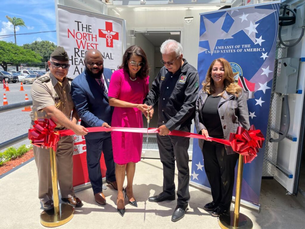 US Southern Command deputy commander for mobilisation and reserve affairs Major General Javier Reina, left; CEO of the North West Regional Health Authority (NWRHA) Major (Ret) Anthony Blake; US Ambassador to TT Candace Bond; Minister of Health Terrence Deyalsingh; and NWRHA chairman Lisa Agard cut the ribbon to the mobile medical units, 