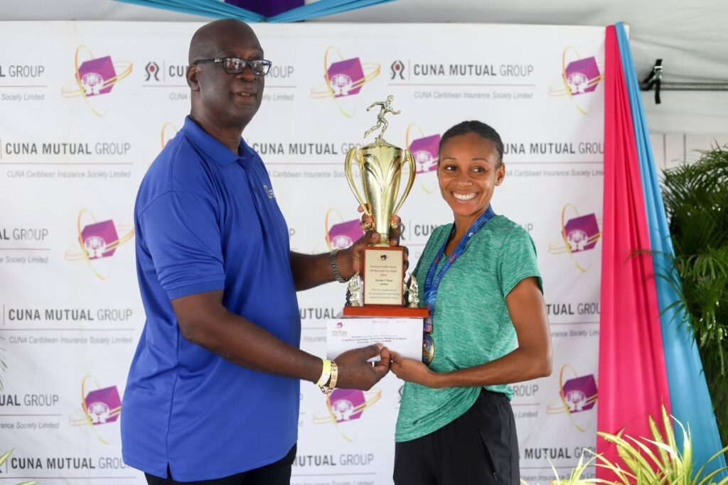 Venture Credit Union 5K women's champion Samantha Shukla, right, collects her trophy for winning her category. - Photos courtesy Venture Credit Union/ Runners Life 