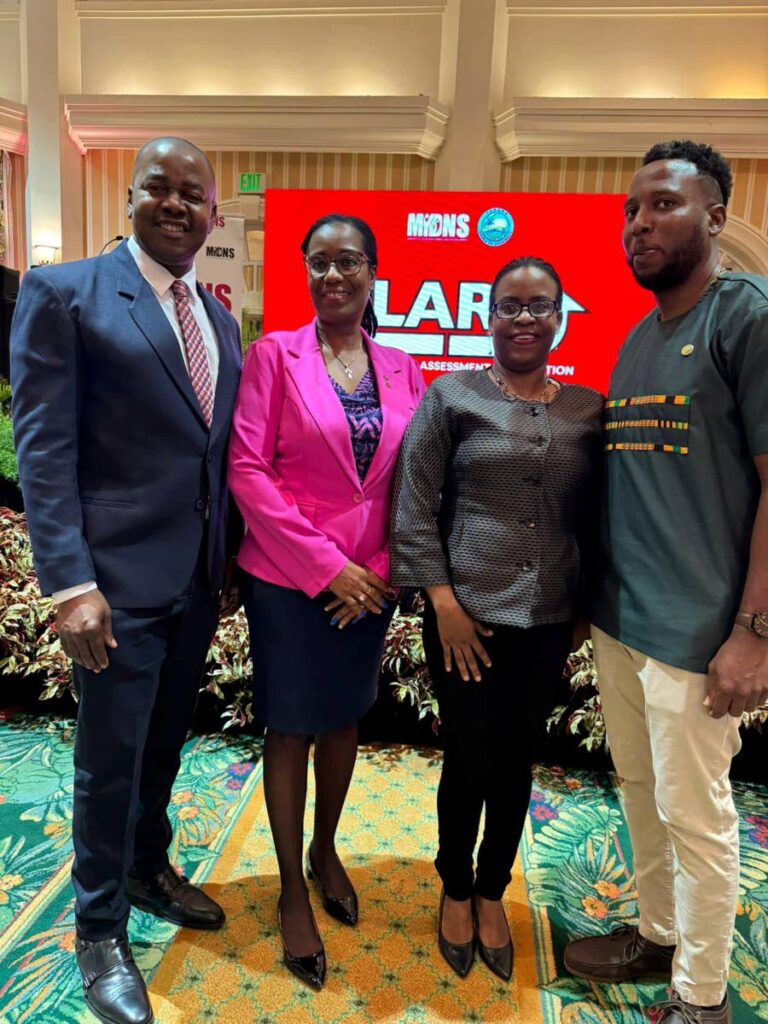 Minister of Youth Development Foster Cummings, left, with Secretary for Youth Development Joel Sampson, right, technical adviser, Division of Education, Ann Natasha Second, and another official at Magdalena Grand Beach and Golf Resort, Lowlands, September 17. - 