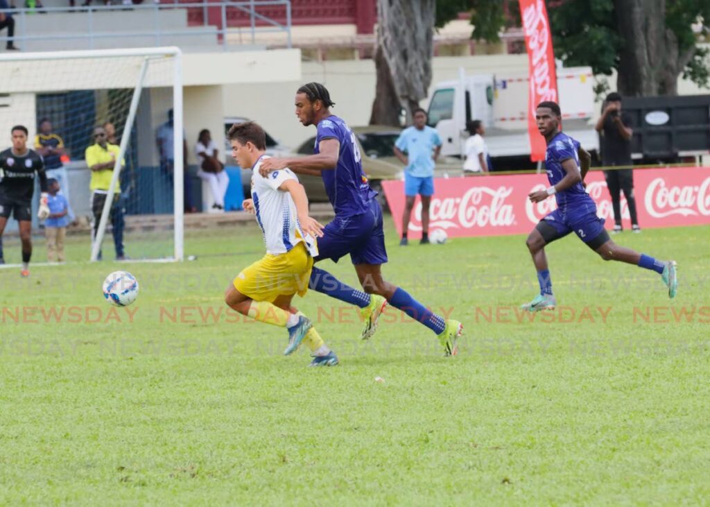 Fatima College’s Michael Chaves (L) battles for possession against a Naparima College player during the Secondary Schools Football League premiership division match, on September 18, 2024, at Fatima Grounds, Mucurapo. - Ayanna Kinsale