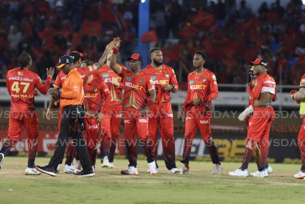 Trinbago Knight Riders teammates celebrate a dismissal against the Guyana Amazon Warriors during the 2024 Republic Bank Caribbean Premier League T20 match, at the Queen's Park Oval, St Clair, Port of Spain, on September 18, 2024.  - Photo by Angelo Marcelle