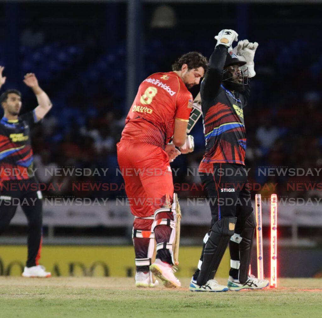 Antigua & Barbuda Falcons wicketkeeper Jahmar Hamilton reacts after almost dismissing Trinbago Knight Riders' Tim David (C) during the Caribbean Premier League T20 match, on September 19, 2024 at the Queen's Park Oval, St Clair. - Angelo Marcelle