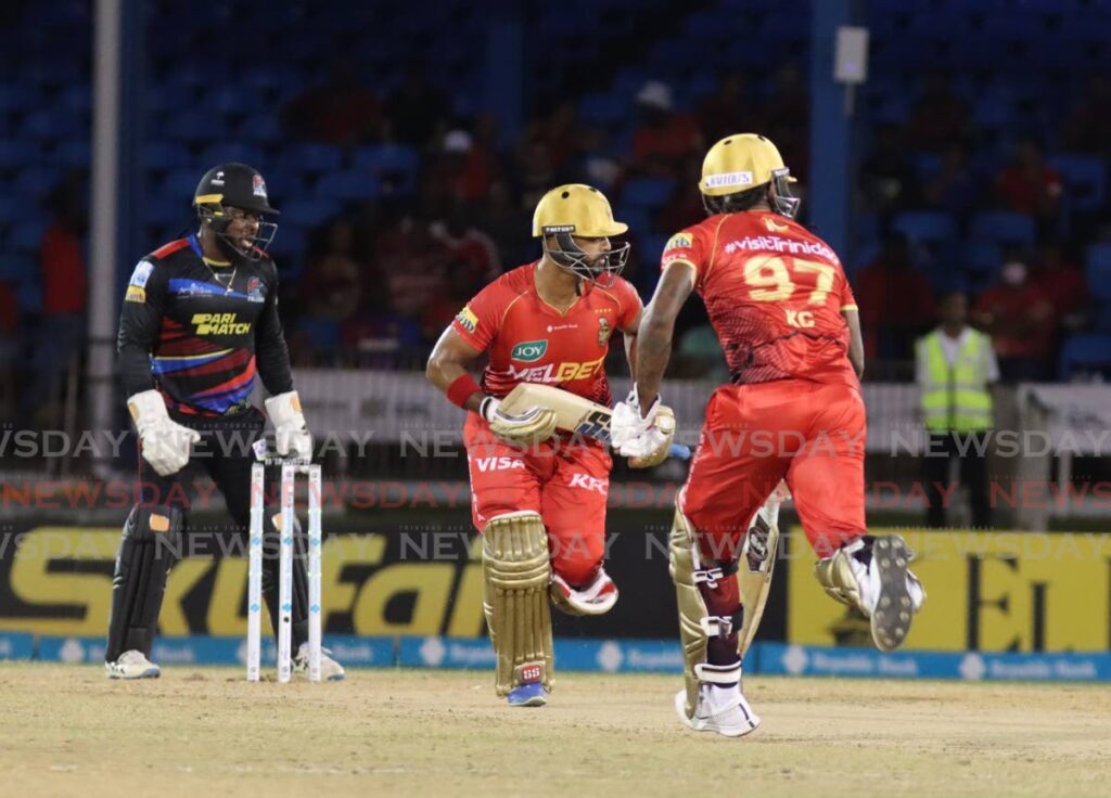 Trinbago Knight Riders batsmen Nicholas Pooran (C) and Kaecy Carty, run between the wickets against Antigua & Barbuda, during the Republic Bank Caribbean Premier League match, at the Queen's Park Oval on September 19.  - Photo by Angelo Marcelle